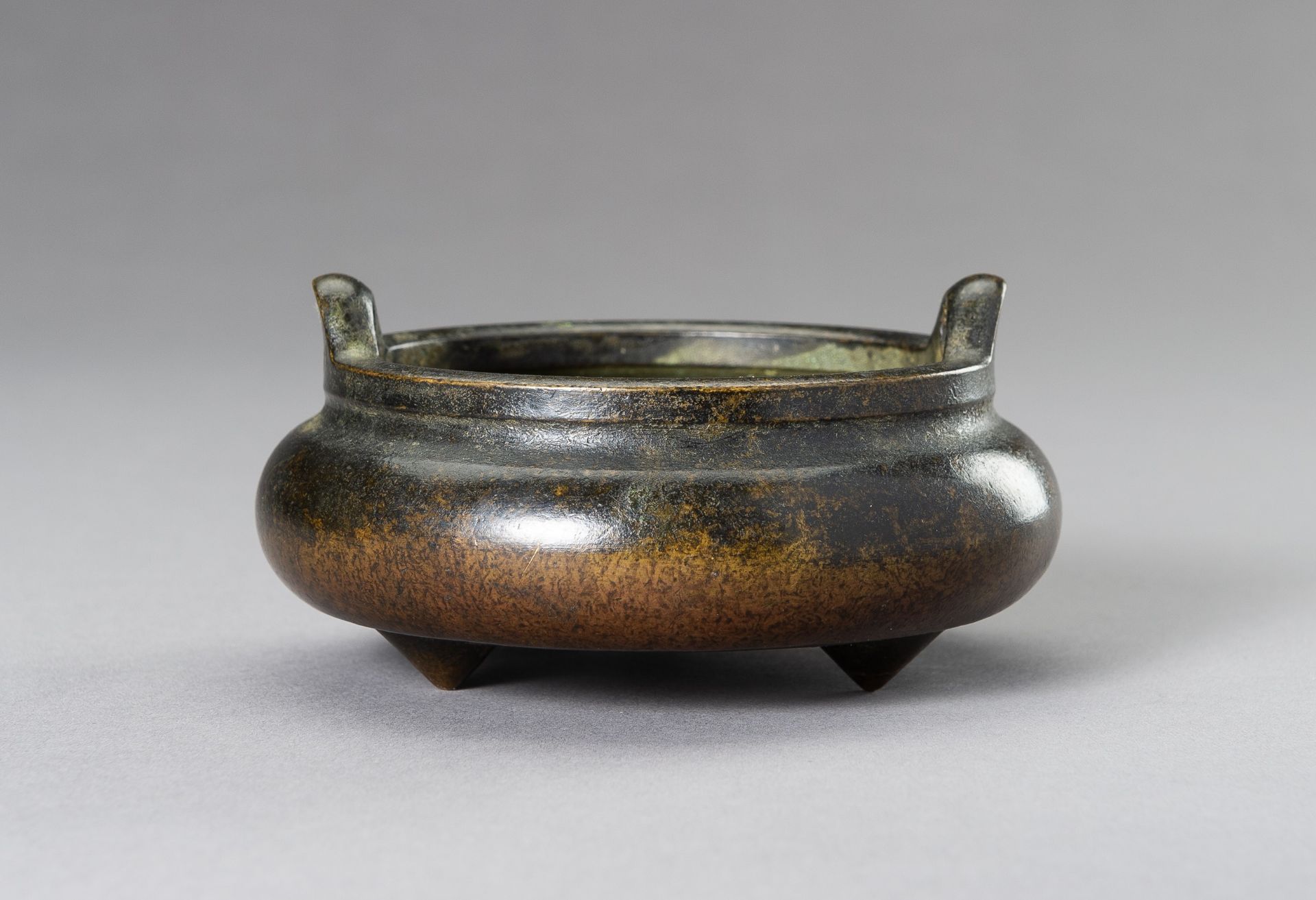 A SMALL BRONZE TRIPOD CENSER