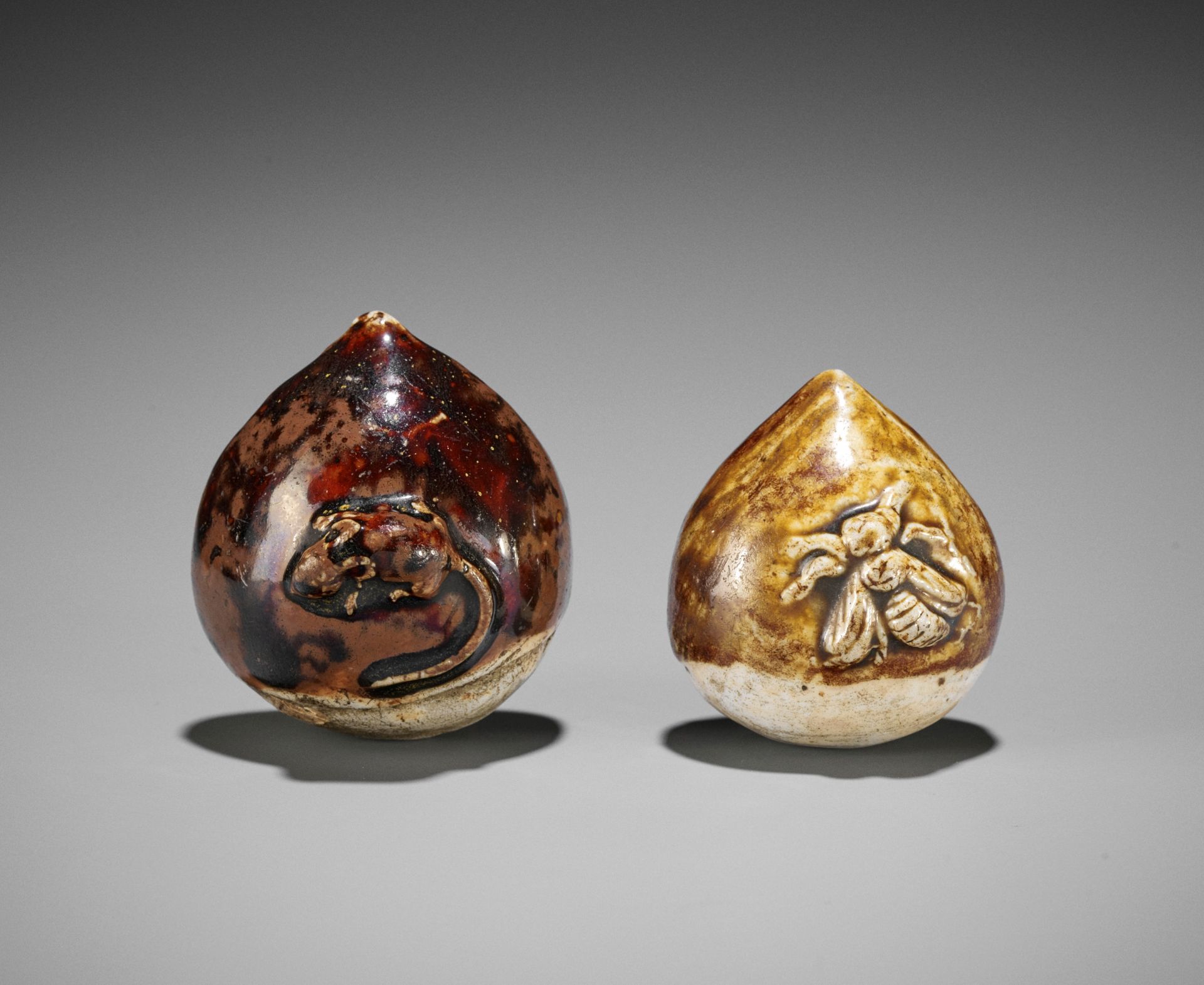 TWO GLAZED CERAMIC (YAKIMONO) NETSUKE OF CHESTNUTS WITH SMALL ANIMALS