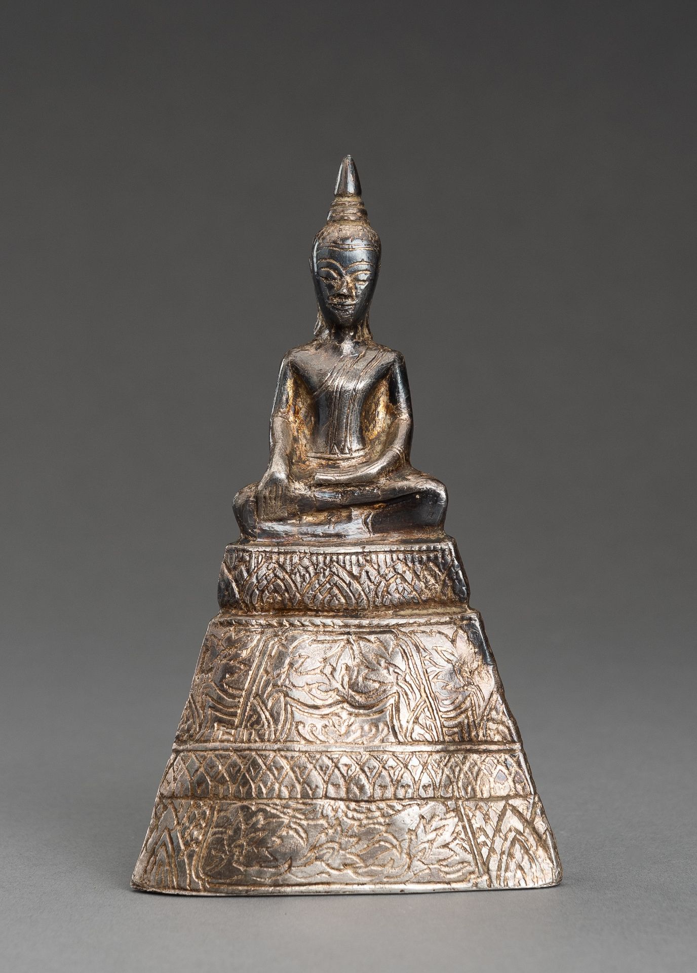 A THAI SILVER FOIL REPOUSSE FIGURE OF BUDDHA, 19th CENTURY