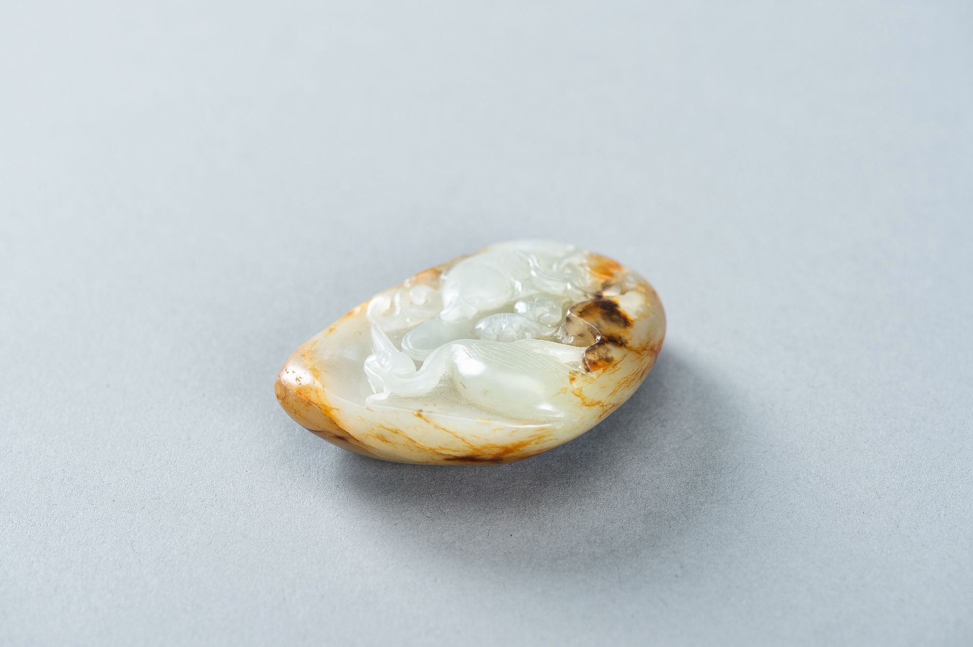 A CELADON AND RUSSET JADE 'FISH AND CRANE' PENDANT, c. 1920s - Image 3 of 9