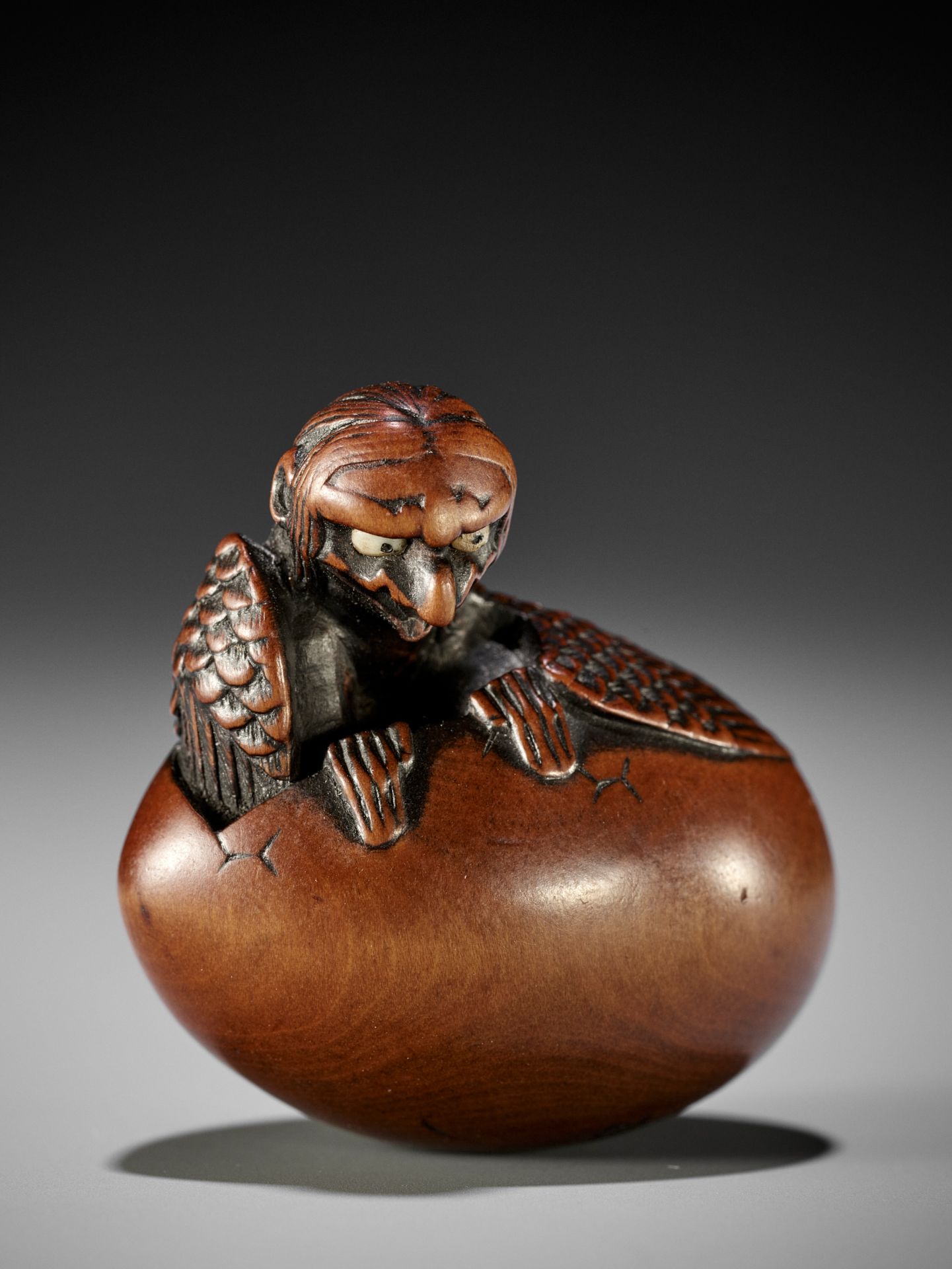 TOYOYO: A FINE WOOD NETSUKE OF A HATCHING TENGU (TENGU NO TOMAGO)