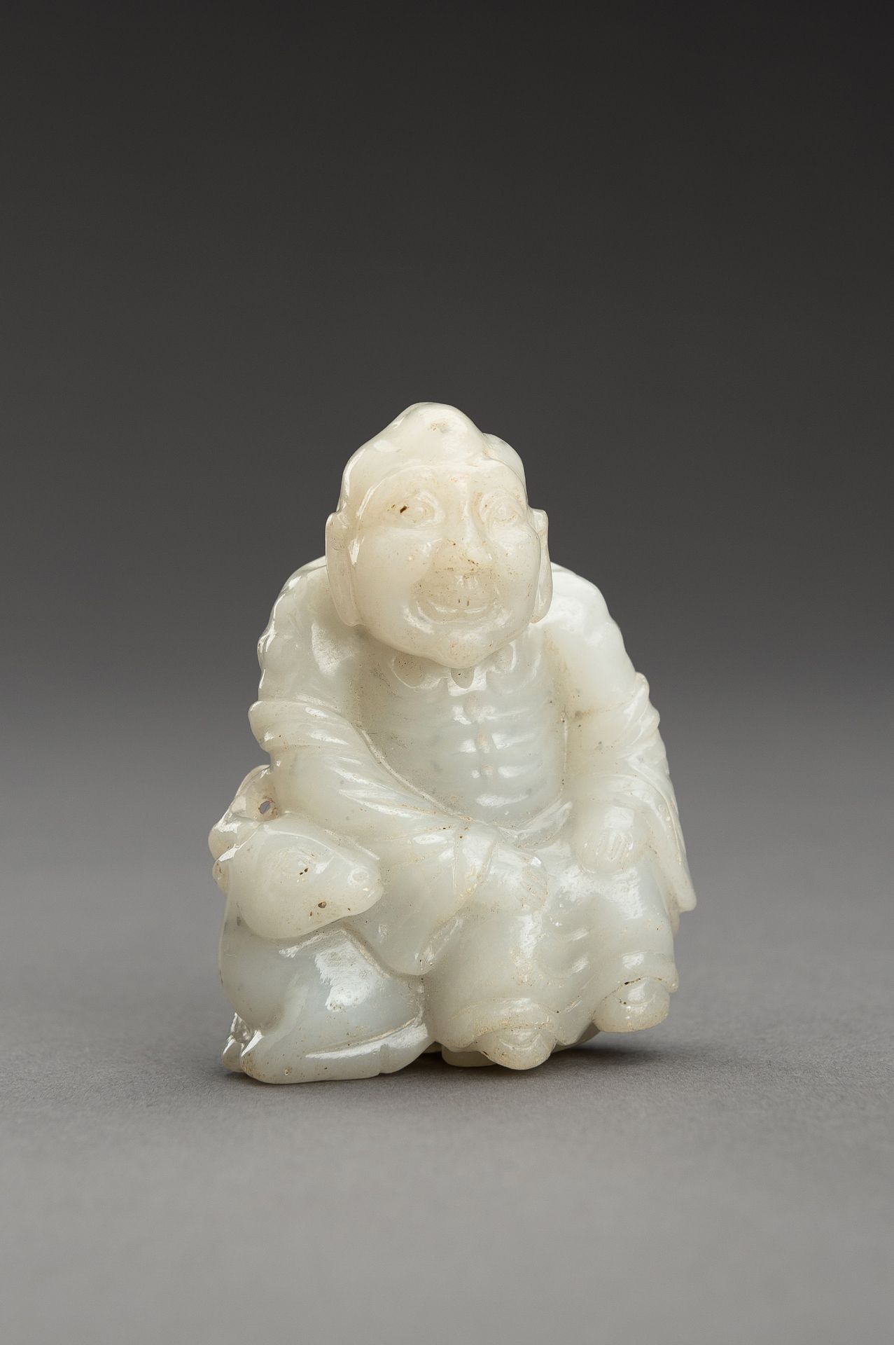 A WHITE JADE GROUP OF A LUOHAN AND DEER