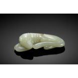 A PALE CELADON JADE CARVING OF A DOG, QING
