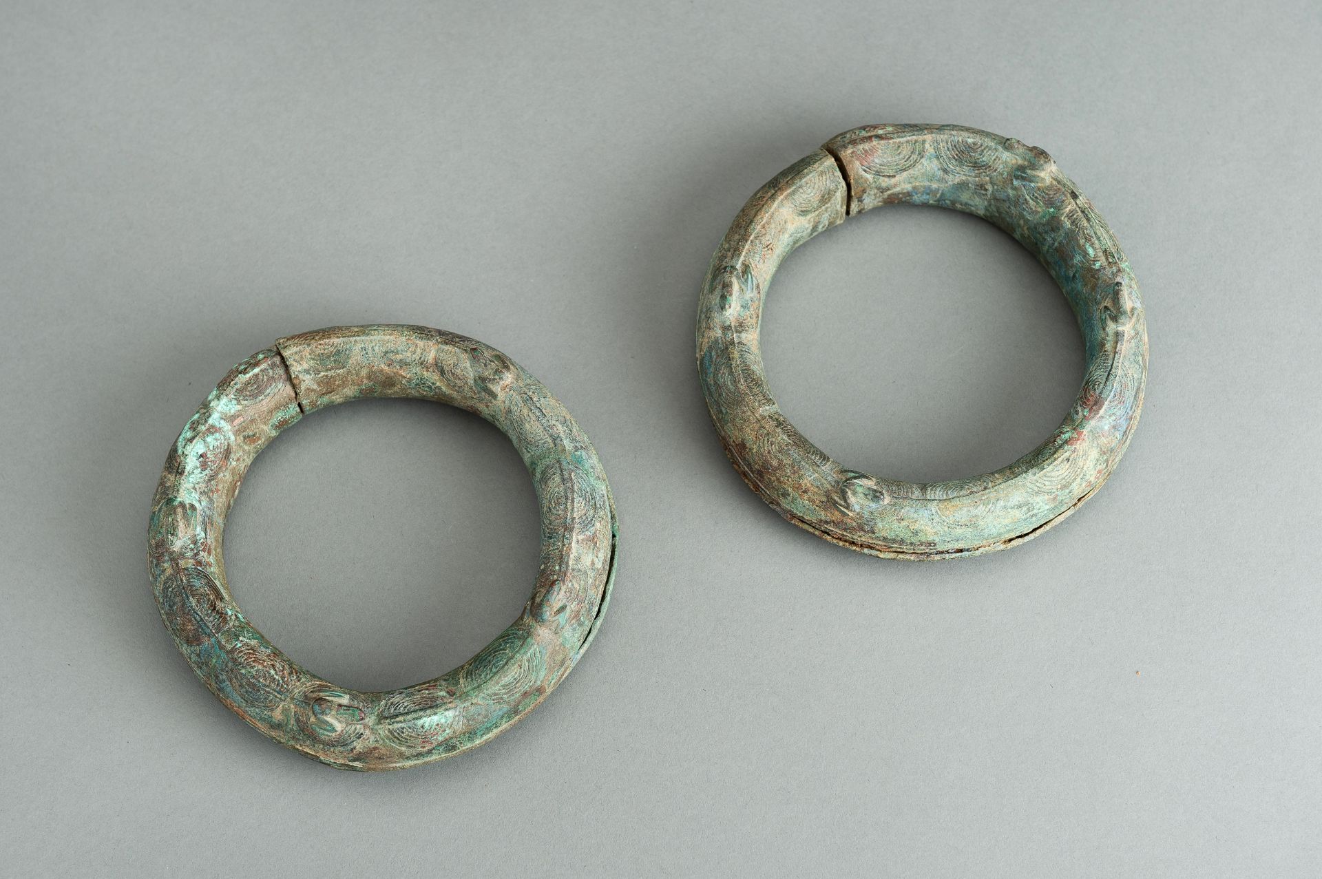 A PAIR OF BRONZE 'FROG' RITUAL BANGLES, DONG SON CULTURE