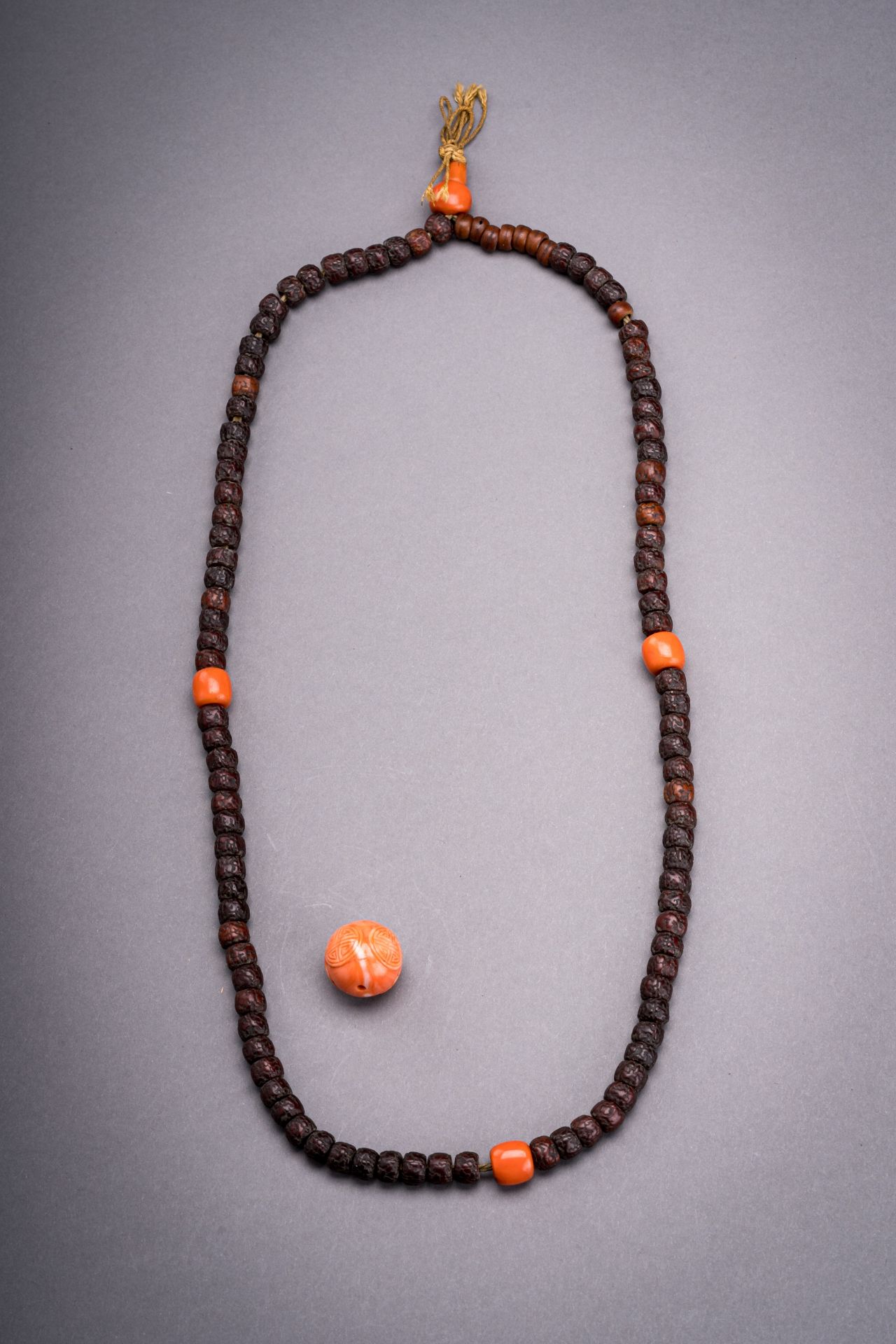 A LOT WITH A 108-BEAD MALA AND A CORAL BEAD