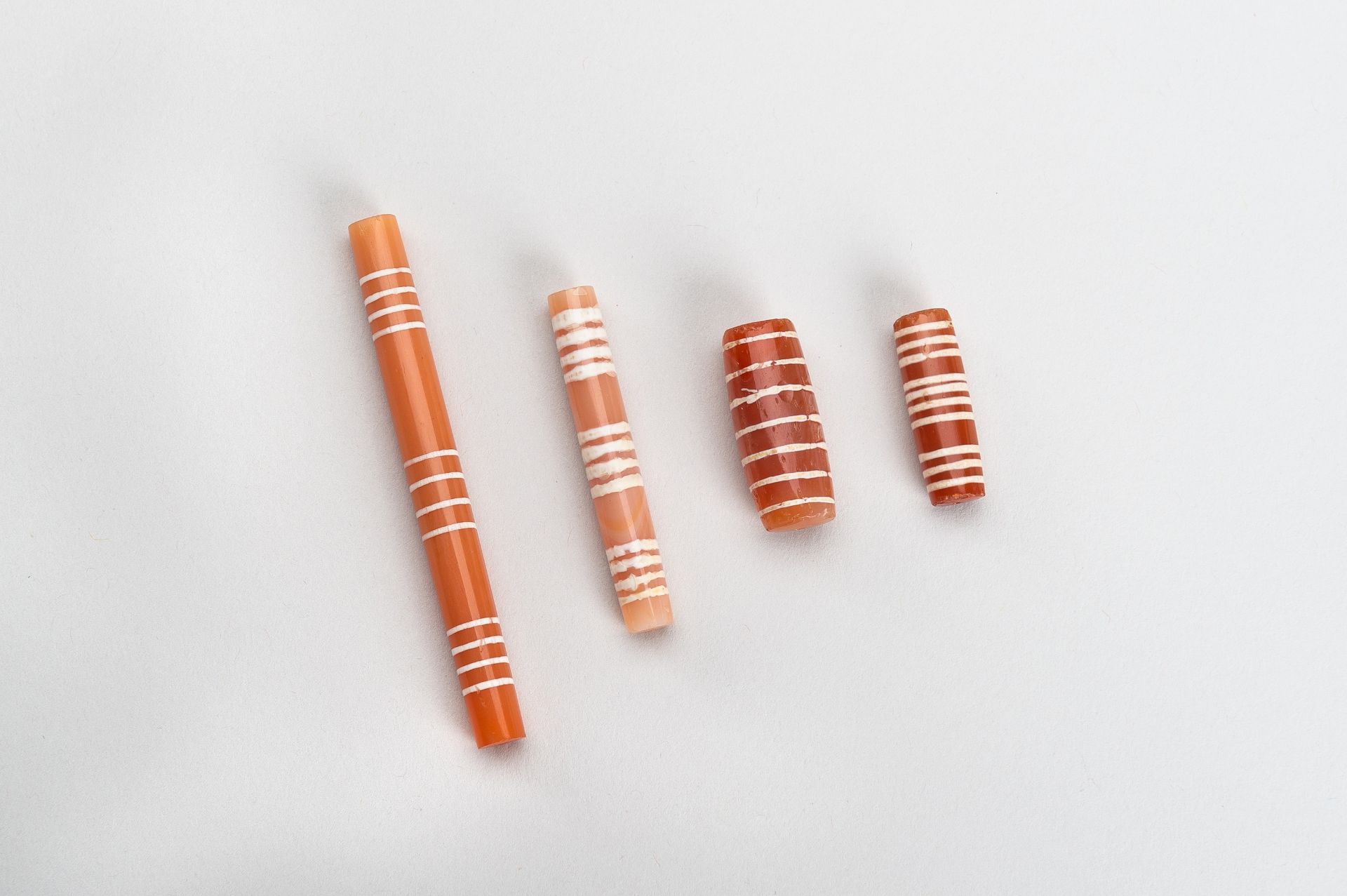 A GROUP OF FOUR ETCHED PYU CARNELIAN BEADS