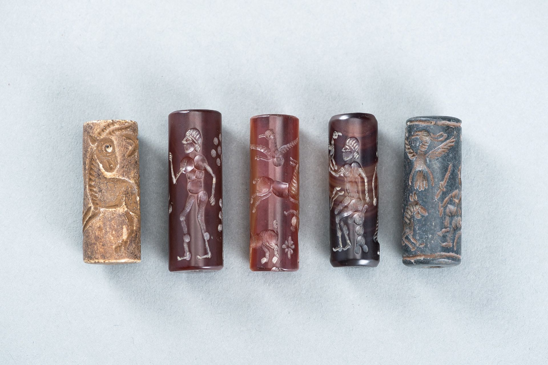 FIVE BACTRIAN STONE AND AGATE CYLINDER SEALS