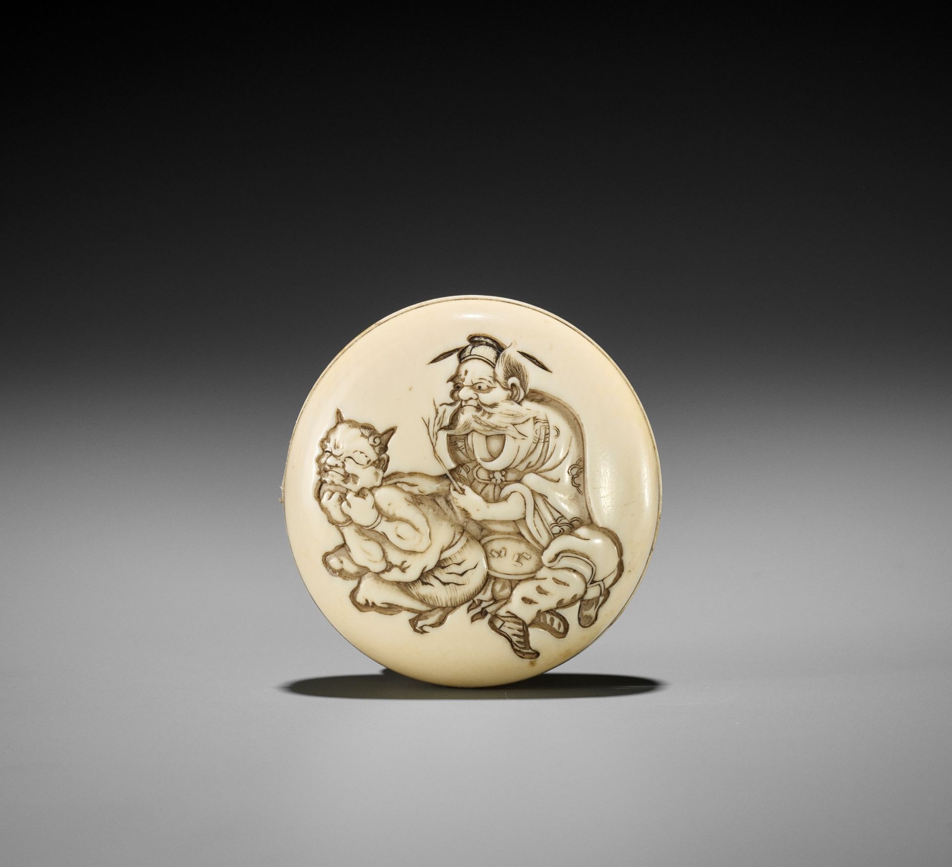 KOJU: AN AMUSING IVORY MANJU NETSUKE OF SHOKI AND ONI