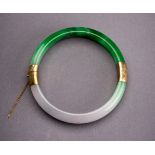 A PALE LAVENDER AND EMERALD GREEN JADEITE BANGLE