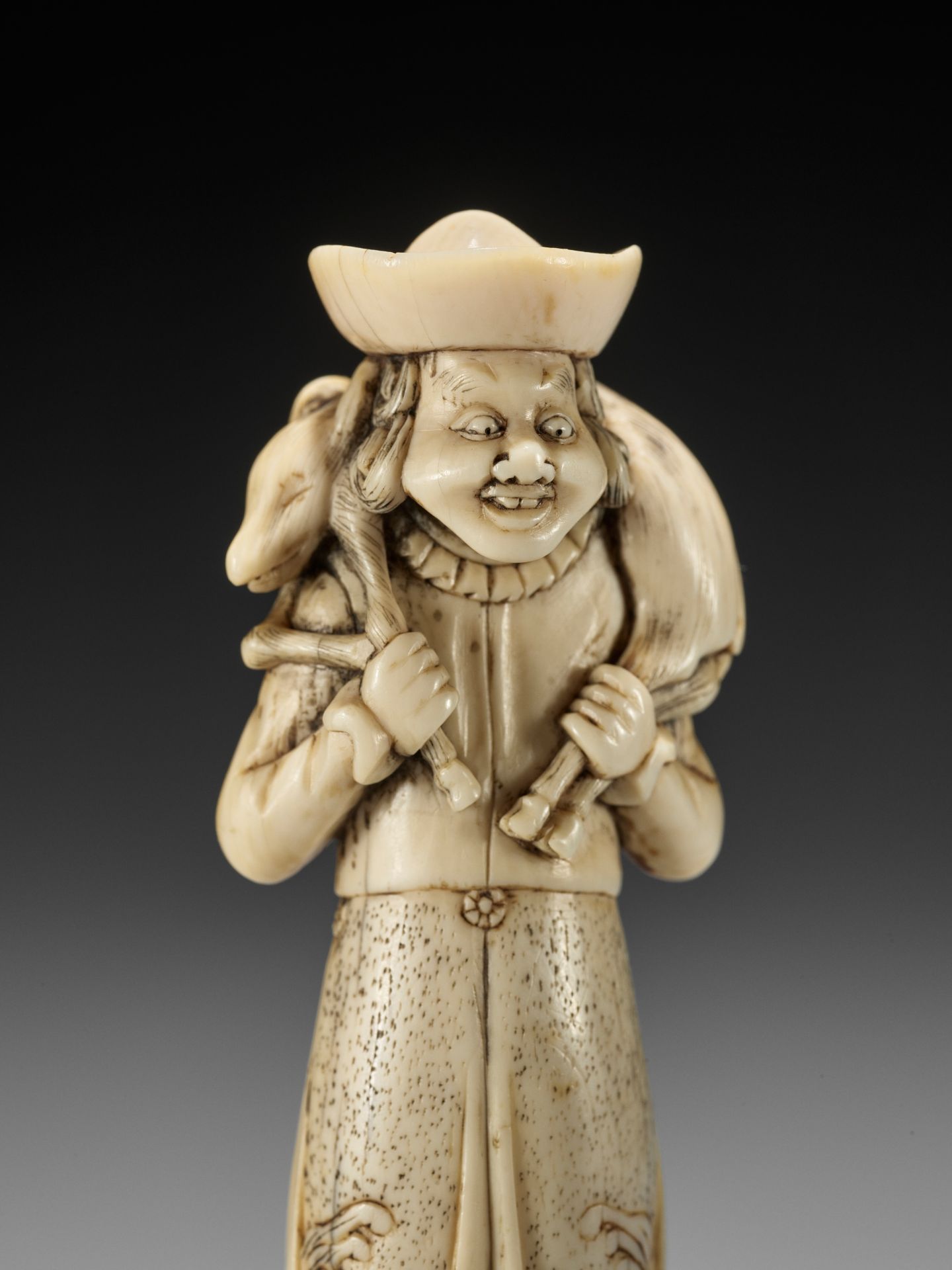 A SUPERB IVORY NETSUKE OF A DUTCHMAN