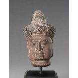 A STONEWARE MUSEUM COPY OF A KHMER HEAD