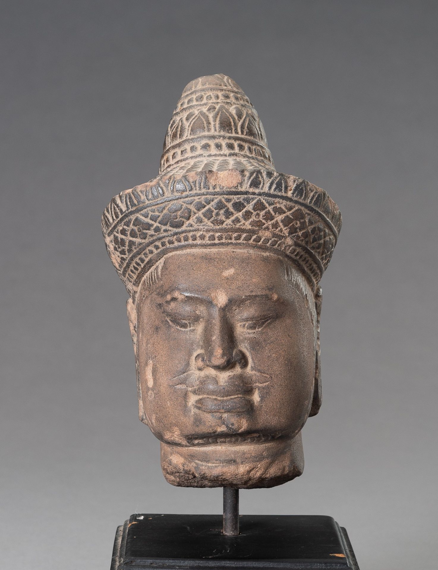 A STONEWARE MUSEUM COPY OF A KHMER HEAD