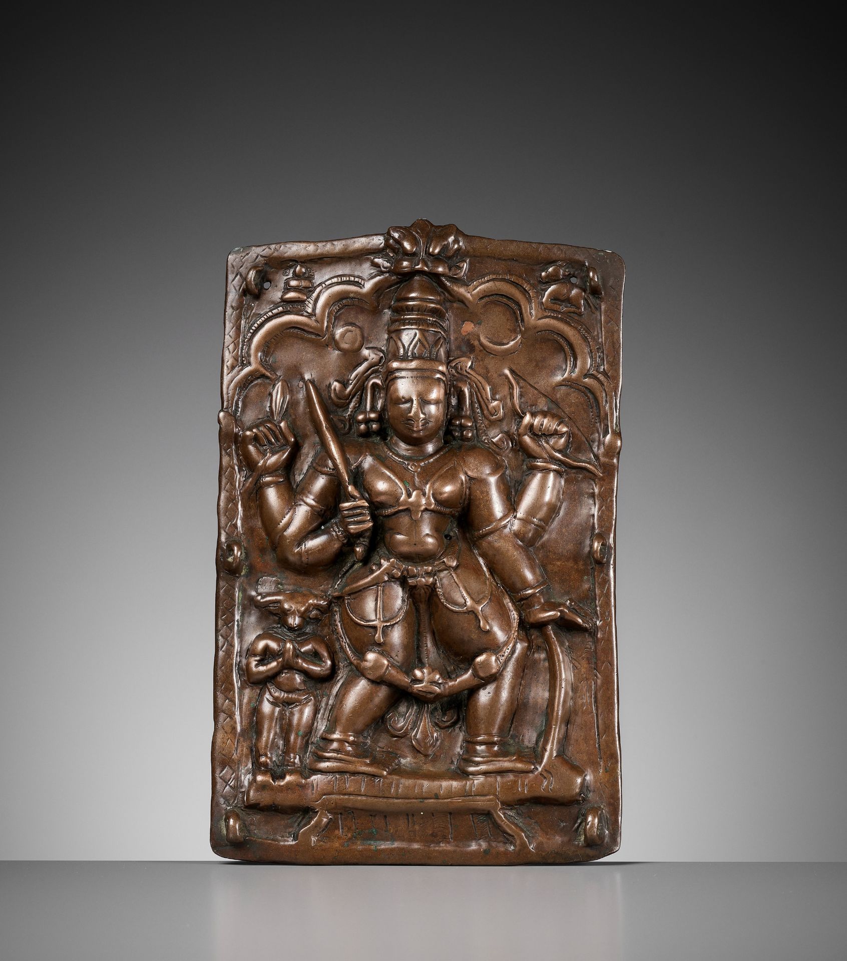 A CEREMONIAL COPPER SHIELD DEPICTING VIRABHADRA, 17TH-18TH CENTURY