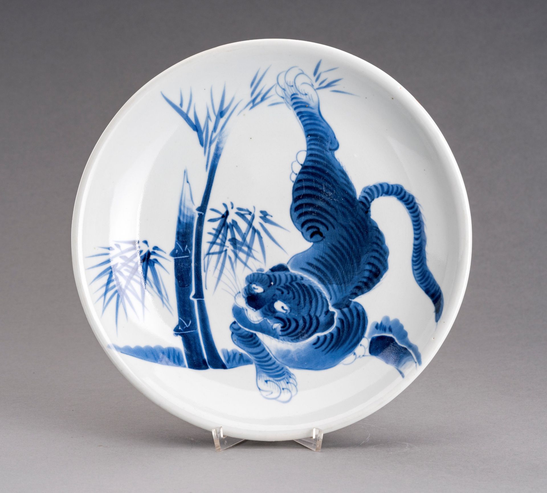 A BLUE AND WHITE ARITA IMARI PORCELAIN DISH 'TIGER AND BAMBOO', MEIJI