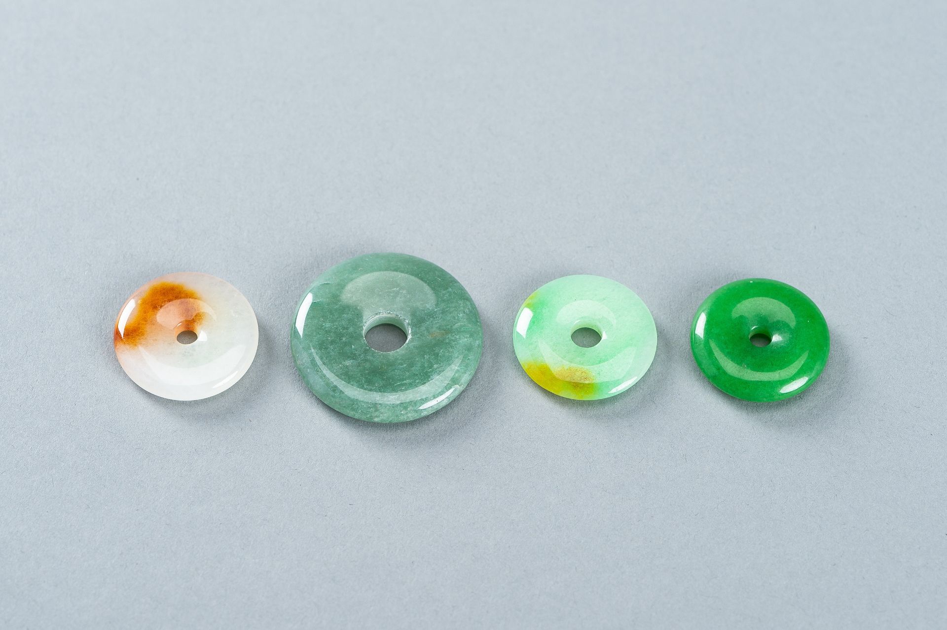 A GROUP OF FOUR JADEITE DISC PENDANTS - Image 10 of 10