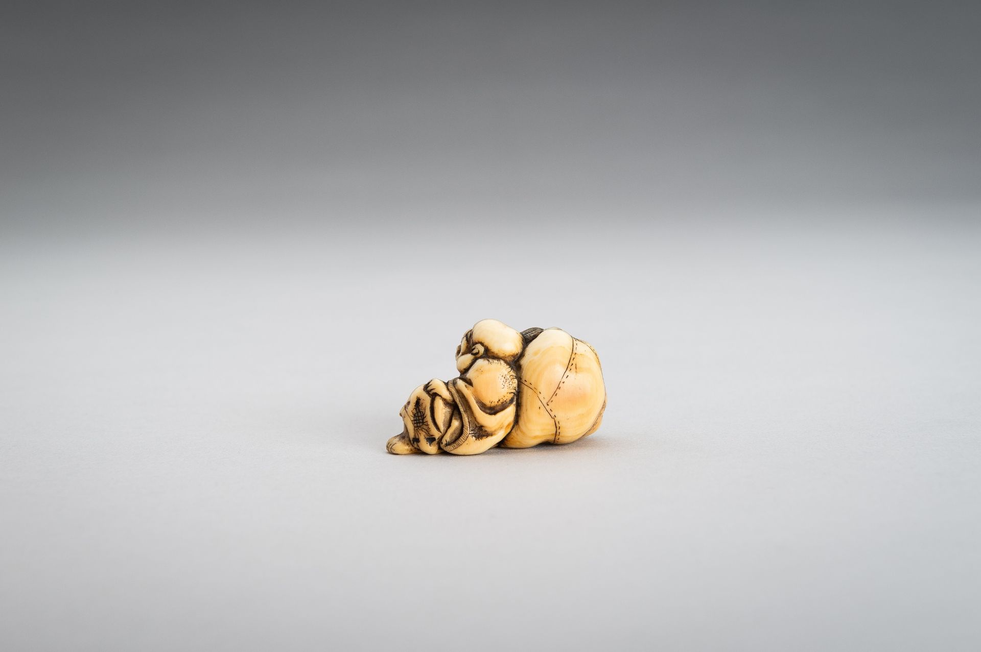 AN IVORY NETSUKE OF HOTEI WITH HIS TREASURE BAG - Bild 5 aus 10