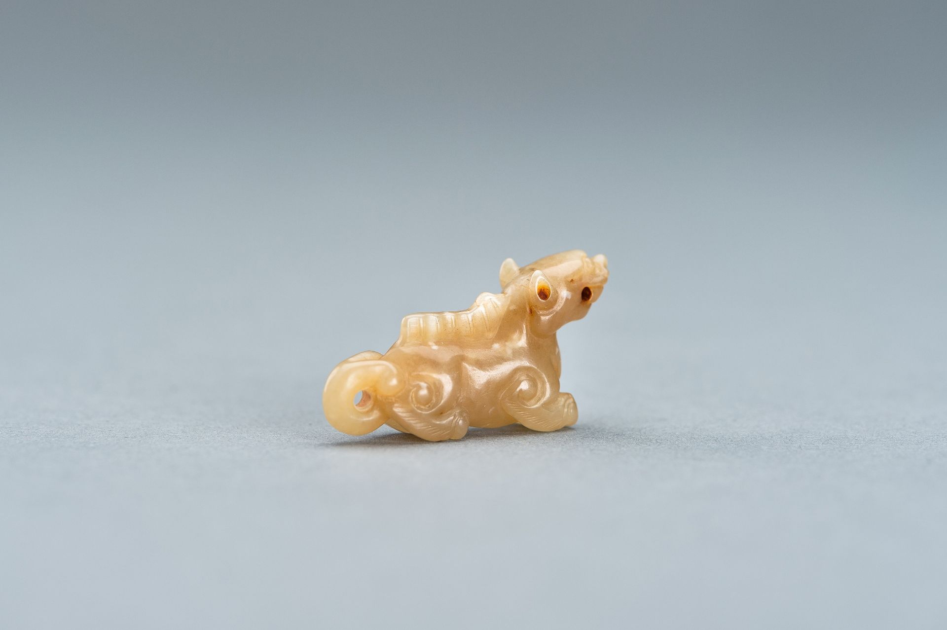 A PALE GREEN MINIATURE CARVING OF A LION, c. 1920s - Image 7 of 13