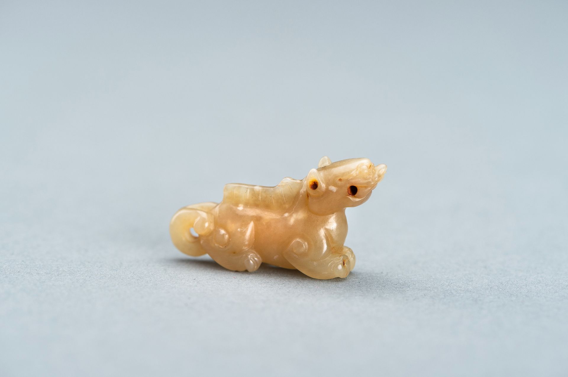 A PALE GREEN MINIATURE CARVING OF A LION, c. 1920s - Image 3 of 13