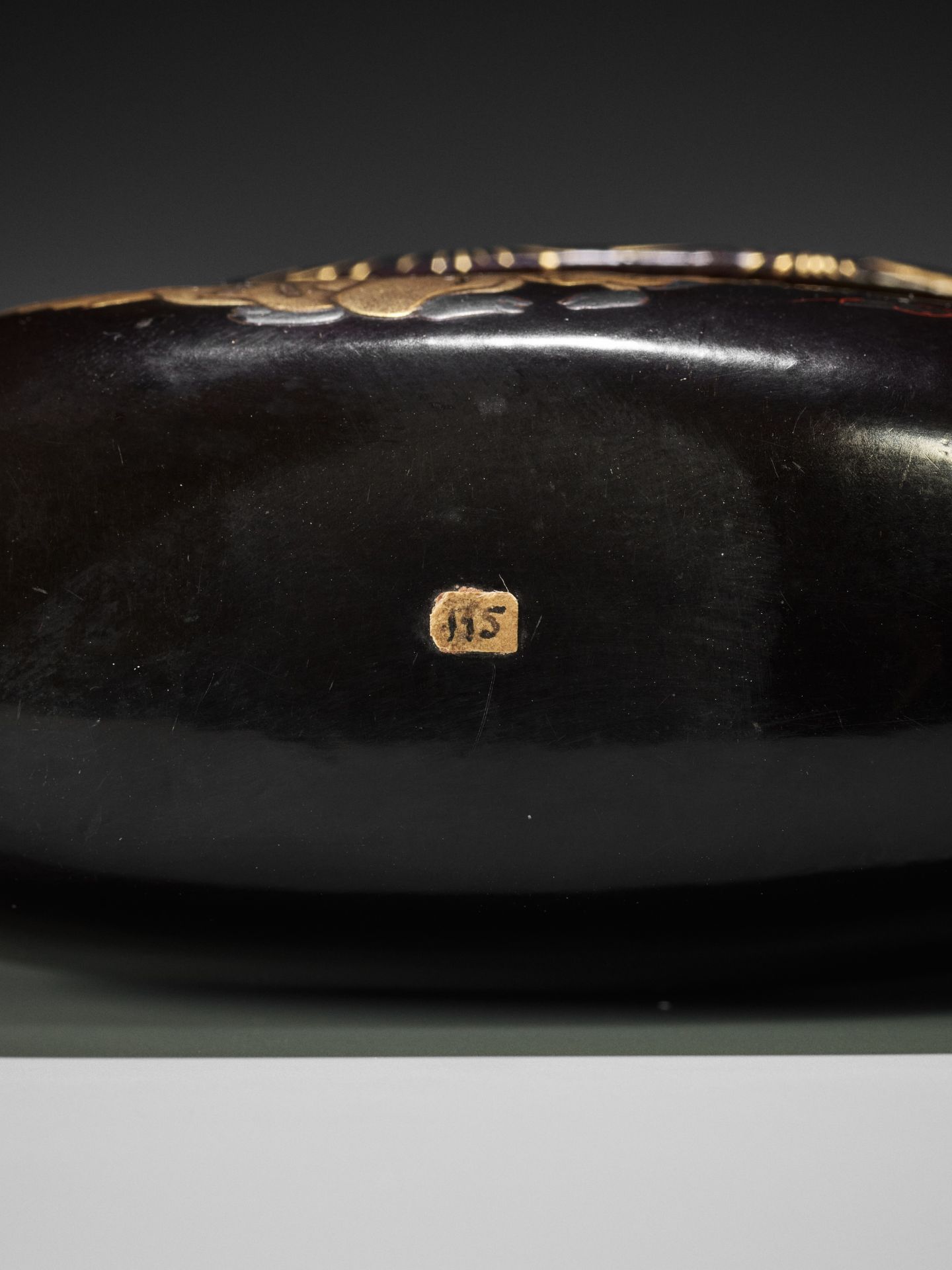 A RARE BLACK AND GOLD LACQUER TONKOTSU DEPICTING A NEW YEAR'S SCENE - Image 7 of 7