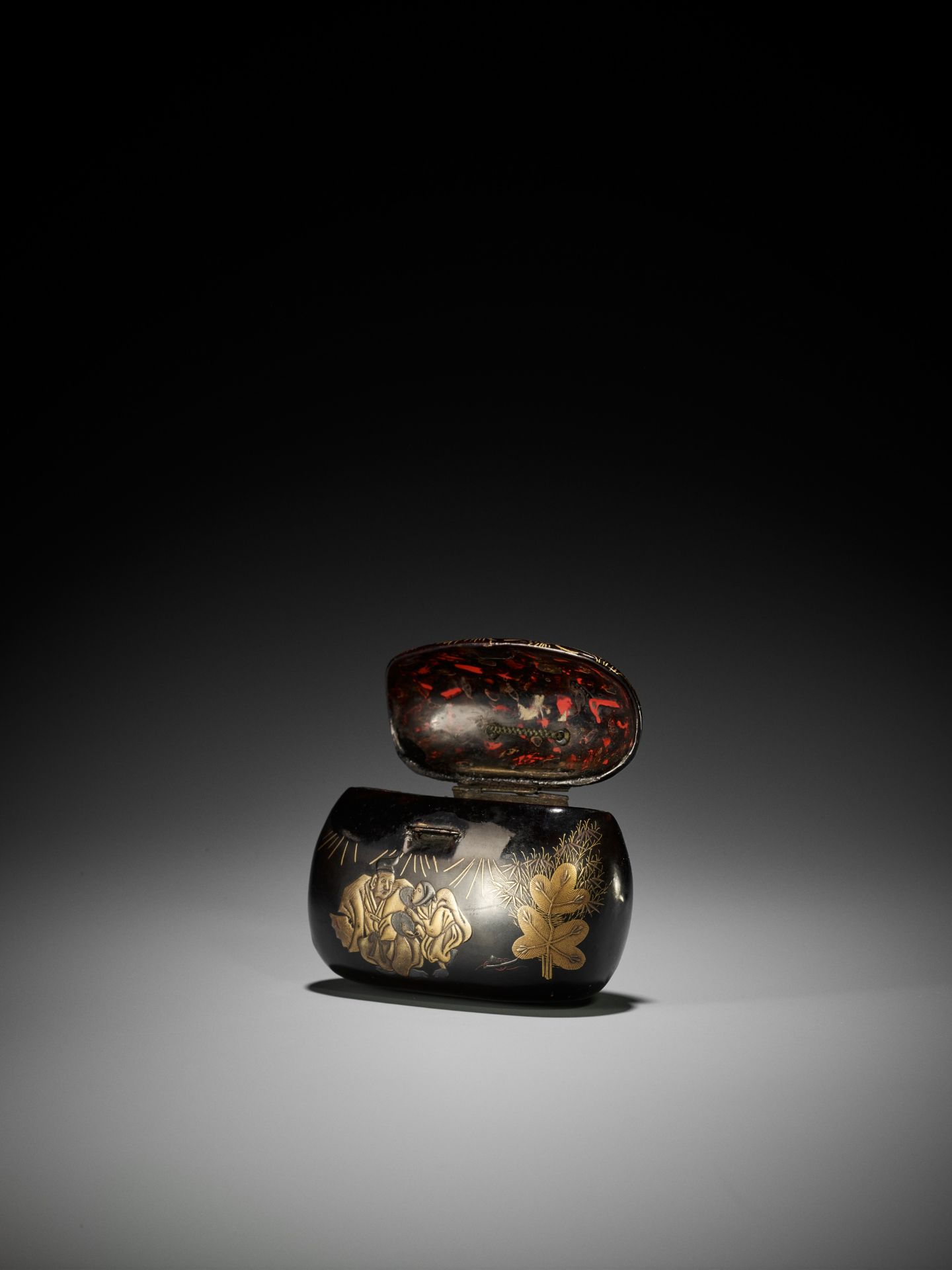 A RARE BLACK AND GOLD LACQUER TONKOTSU DEPICTING A NEW YEAR'S SCENE - Image 2 of 7