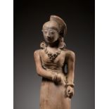A MAGNIFICENT AND VERY LARGE TERRACOTTA FIGURE OF A STANDING BEAUTY, MAJAPAHIT PERIOD