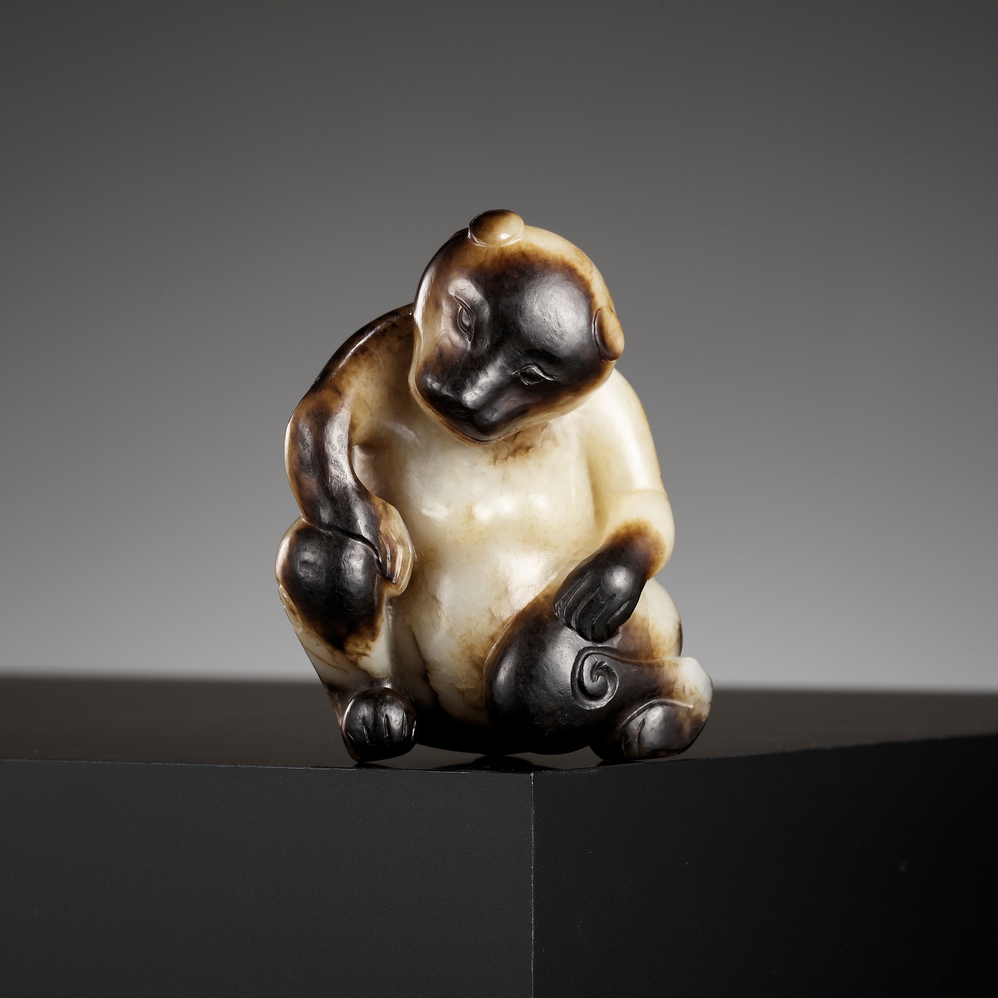 AN EXCEPTIONAL CREAMY-WHITE AND BLACK JADE FIGURE OF A BEAR, SONG DYNASTY OR EARLIER