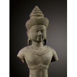 A SANDSTONE FIGURE OF A MALE DEITY, ANGKOR WAT PERIOD, BAPHUON STYLE