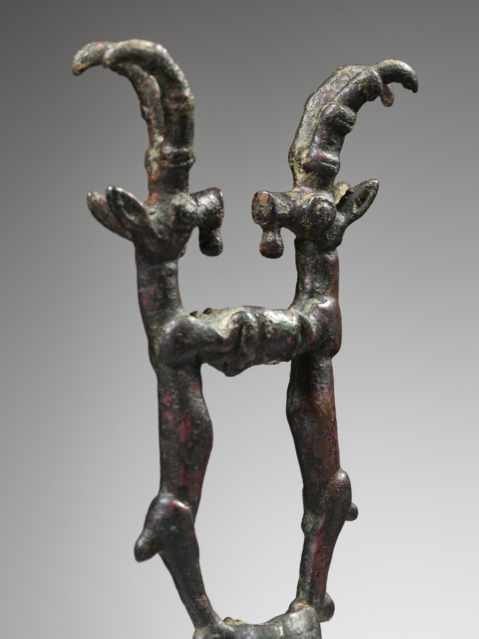 A LURISTAN BRONZE 'DOUBLE IBEX' FINIAL, IRAN, CIRCA 1350-1000 BC