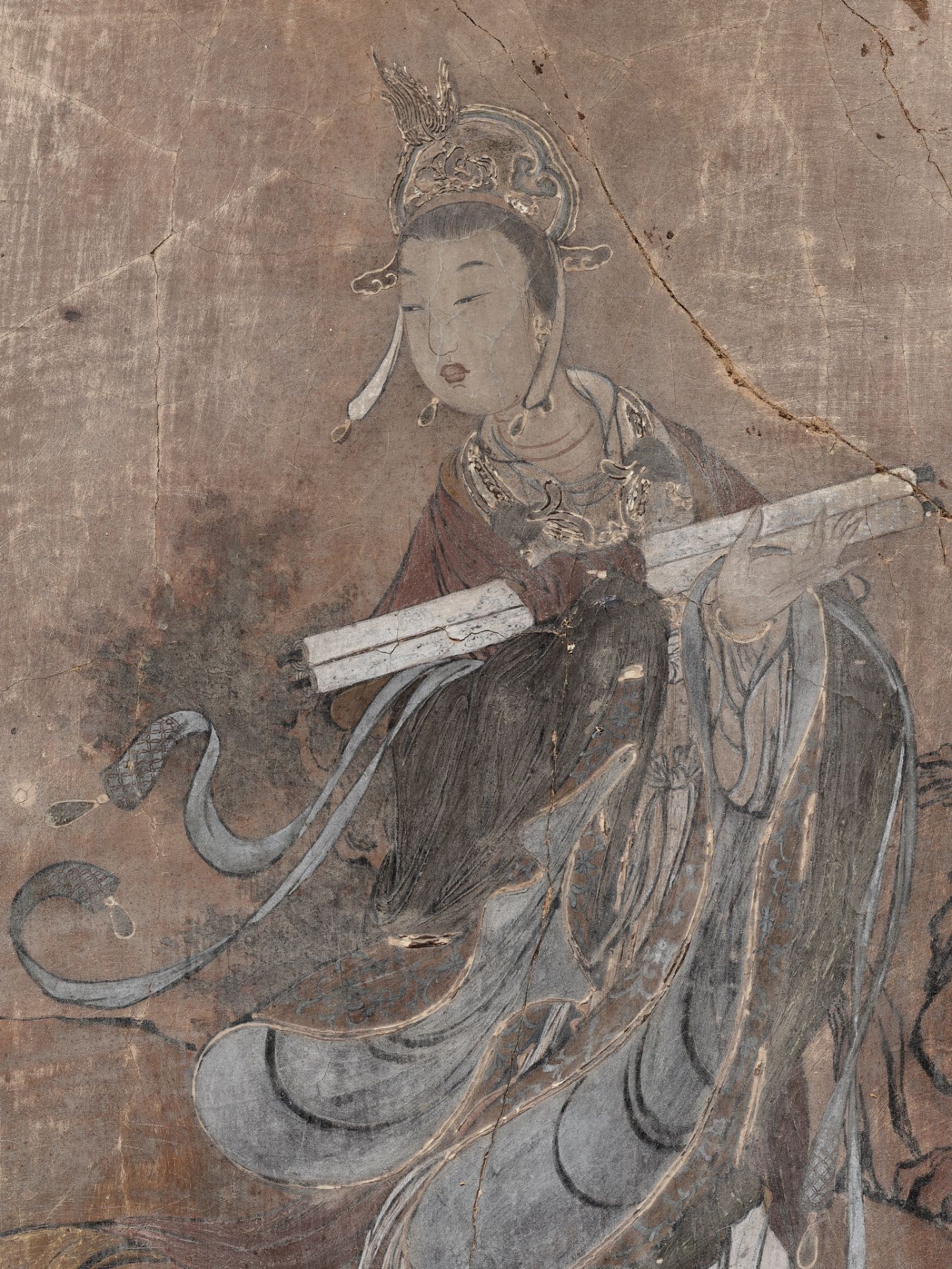 A STUCCO FRESCO FRAGMENT DEPICTING A CELESTIAL MAIDEN, YUAN TO MING DYNASTY