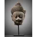 A SANDSTONE HEAD OF GARUDA, KOH KER STYLE, KHMER EMPIRE, 10TH CENTURY