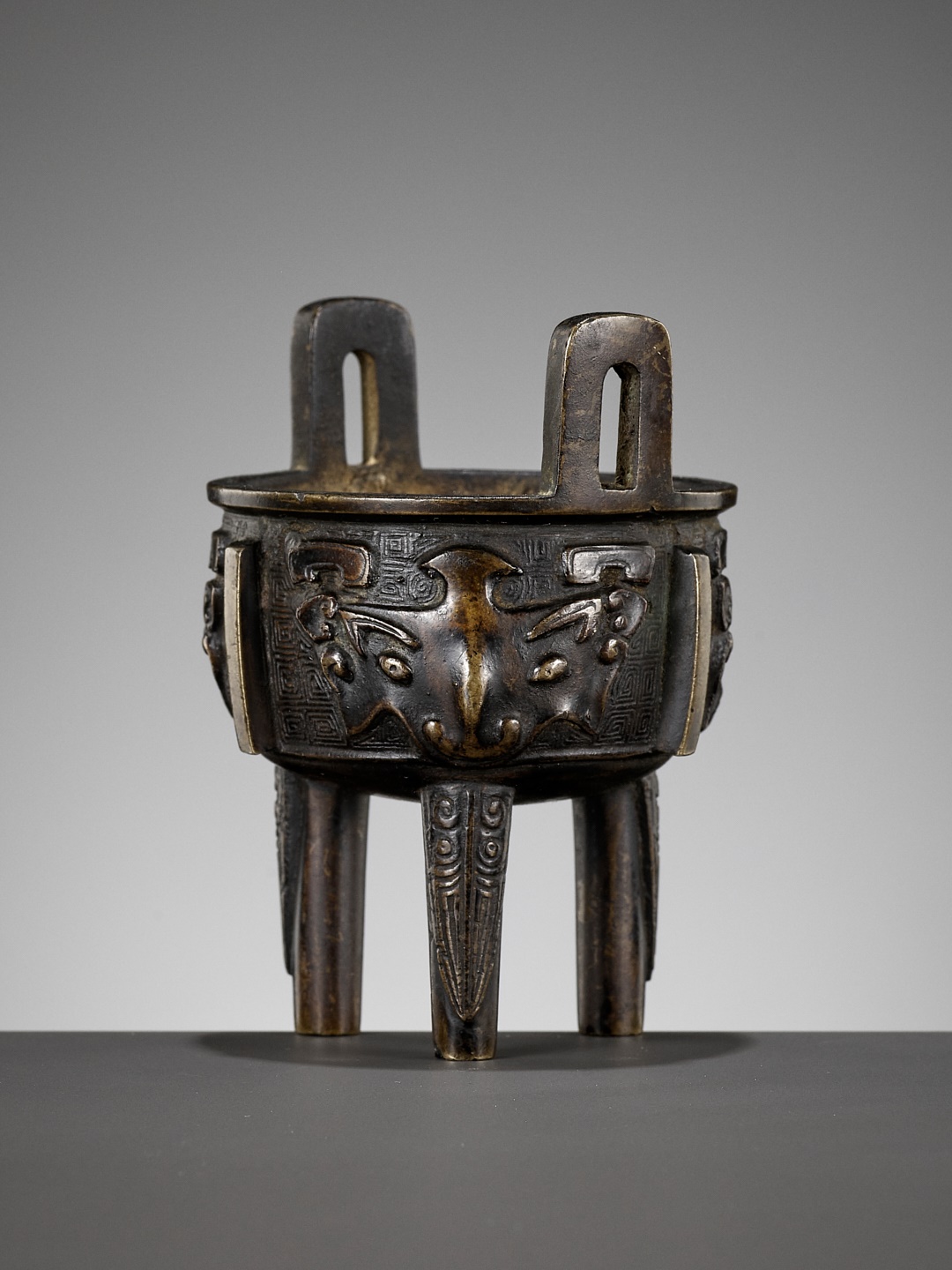 A BRONZE ARCHAISTIC MINIATURE TRIPOD CENSER, DING, QING DYNASTY, 17TH CENTURY
