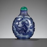 A SAPPHIRE-BLUE OVERLAY 'MONKEY KING STEALING THE PEACHES OF IMMORTALITY' GLASS SNUFF BOTTLE