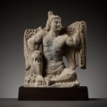 A GRAY SCHIST FIGURE OF A WINGED ATLAS, ANCIENT REGION OF GANDHARA, 3RD - 4TH CENTURY