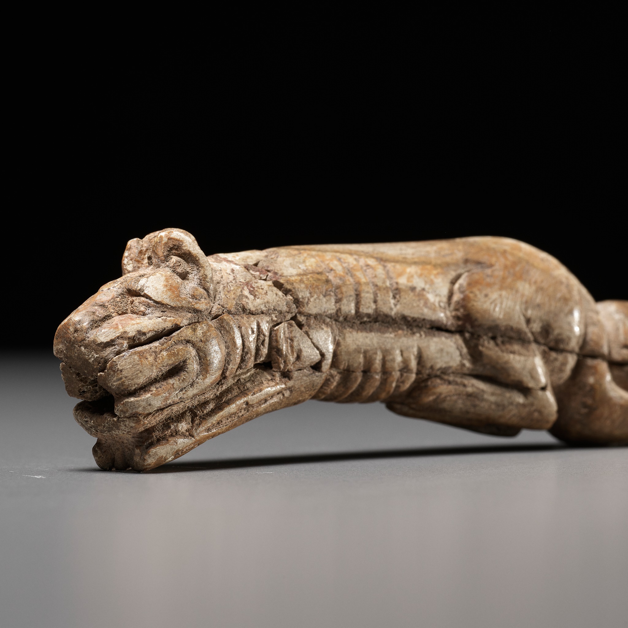 A RARE CARVED BONE FIGURE OF A TIGER, SHANG DYNASTY