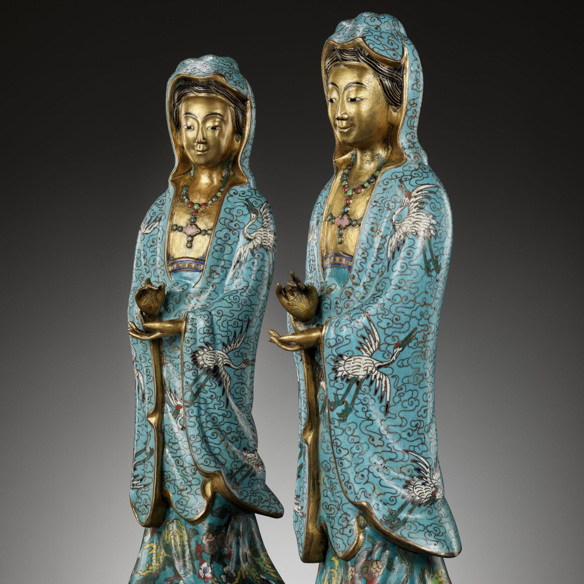 A RARE PAIR OF CLOISONNE ENAMEL FIGURES DEPICTING GUANYIN, QING DYNASTY