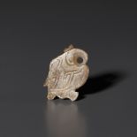 A PALE CELADON AND RUSSET JADE 'BIRD' PENDANT, LATE SHANG DYNASTY