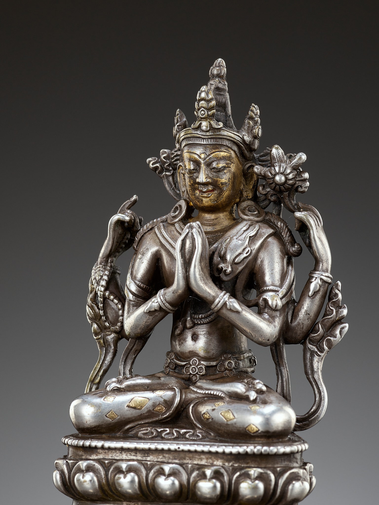 A PARCEL-GILT SOLID SILVER FIGURE OF SHADAKSHARI LOKESHVARA, PALA REVIVAL, TIBET, 17TH-18TH CENTURY