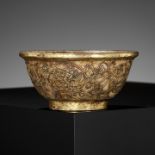 A GILT-COPPER REPOUSSE AND PALE CELADON JADE BOWL, LIAO DYNASTY