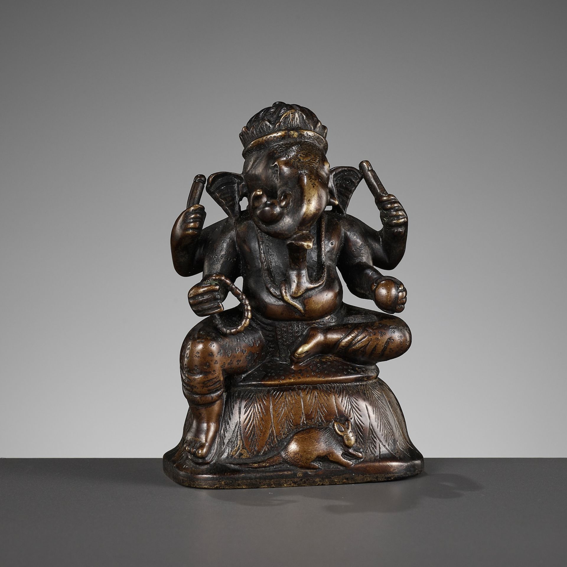 A SMALL BRONZE FIGURE OF GANESHA, SOUTH INDIA, 17TH - 18TH CENTURY