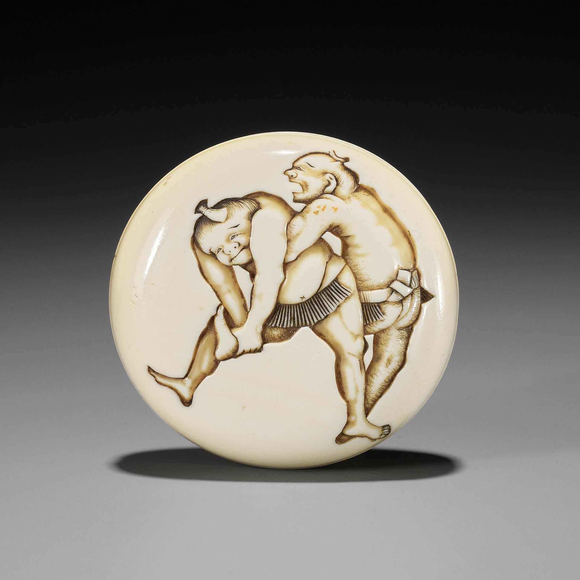 DOSHO: AN IVORY MANJU NETSUKE OF TWO SUMO WRESTLERS