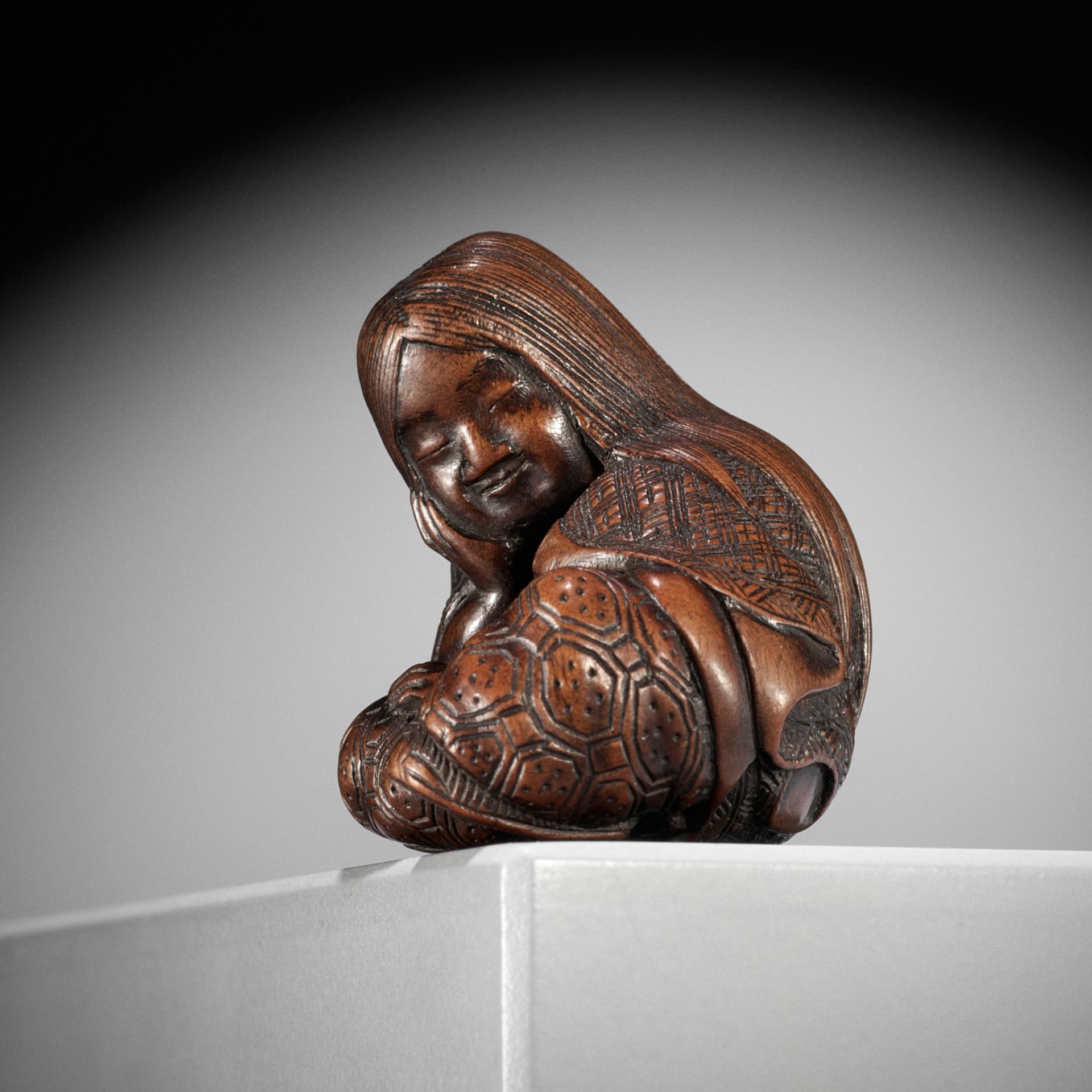 MASATOSHI: A NAGOYA SCHOOL WOOD NETSUKE OF A SLUMBERING SHOJO