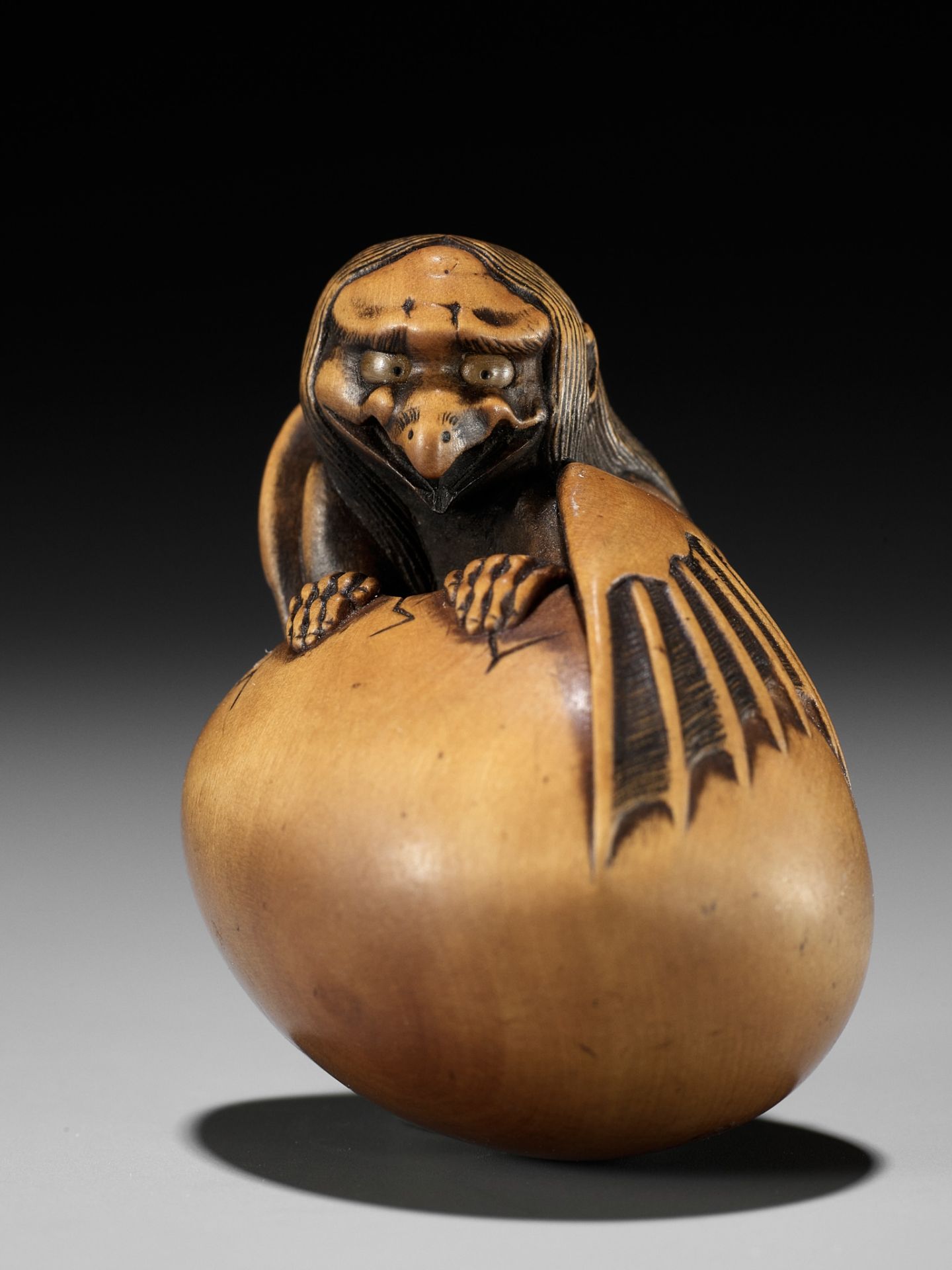 TOYOMASA: A SUPERB WOOD NETSUKE OF A HATCHING TENGU (TENGU NO TAMAGO)