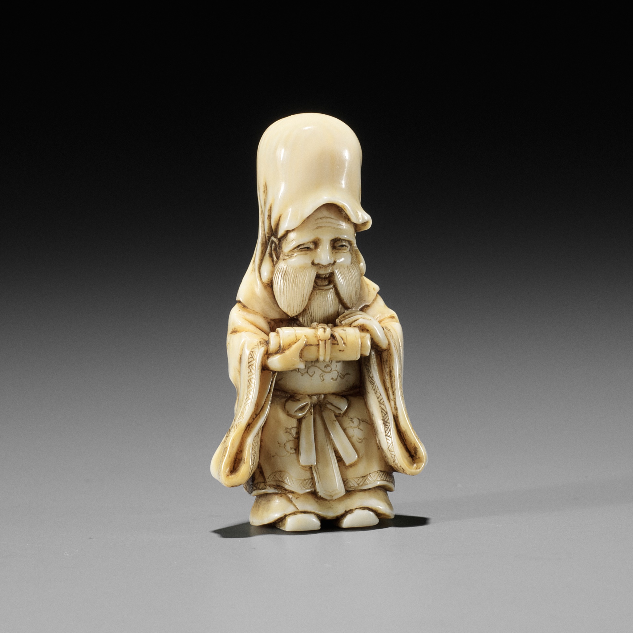 GYOKKOSAI: A FINE IVORY NETSUKE OF JUROJIN HOLDING A SCROLL