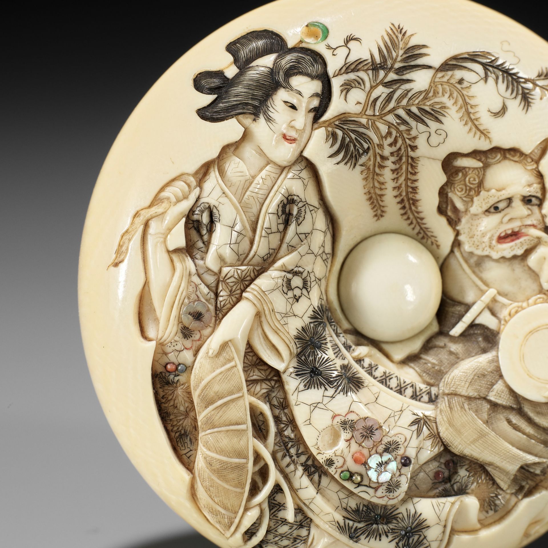 KIKUGAWA: A LARGE IVORY MANJU NETSUKE WITH OTSU-E MOTIF