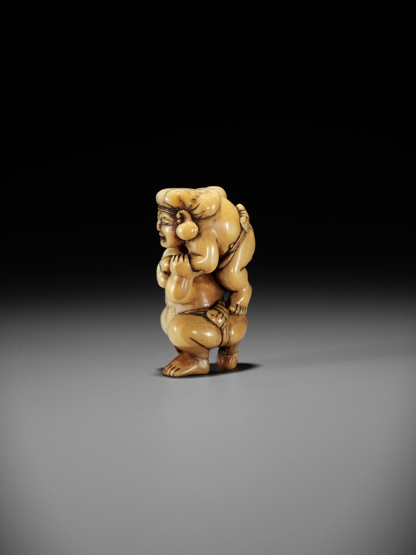 AN IVORY NETSUKE OF HOTEI AND DAIKOKU WRESTLING - Image 7 of 13