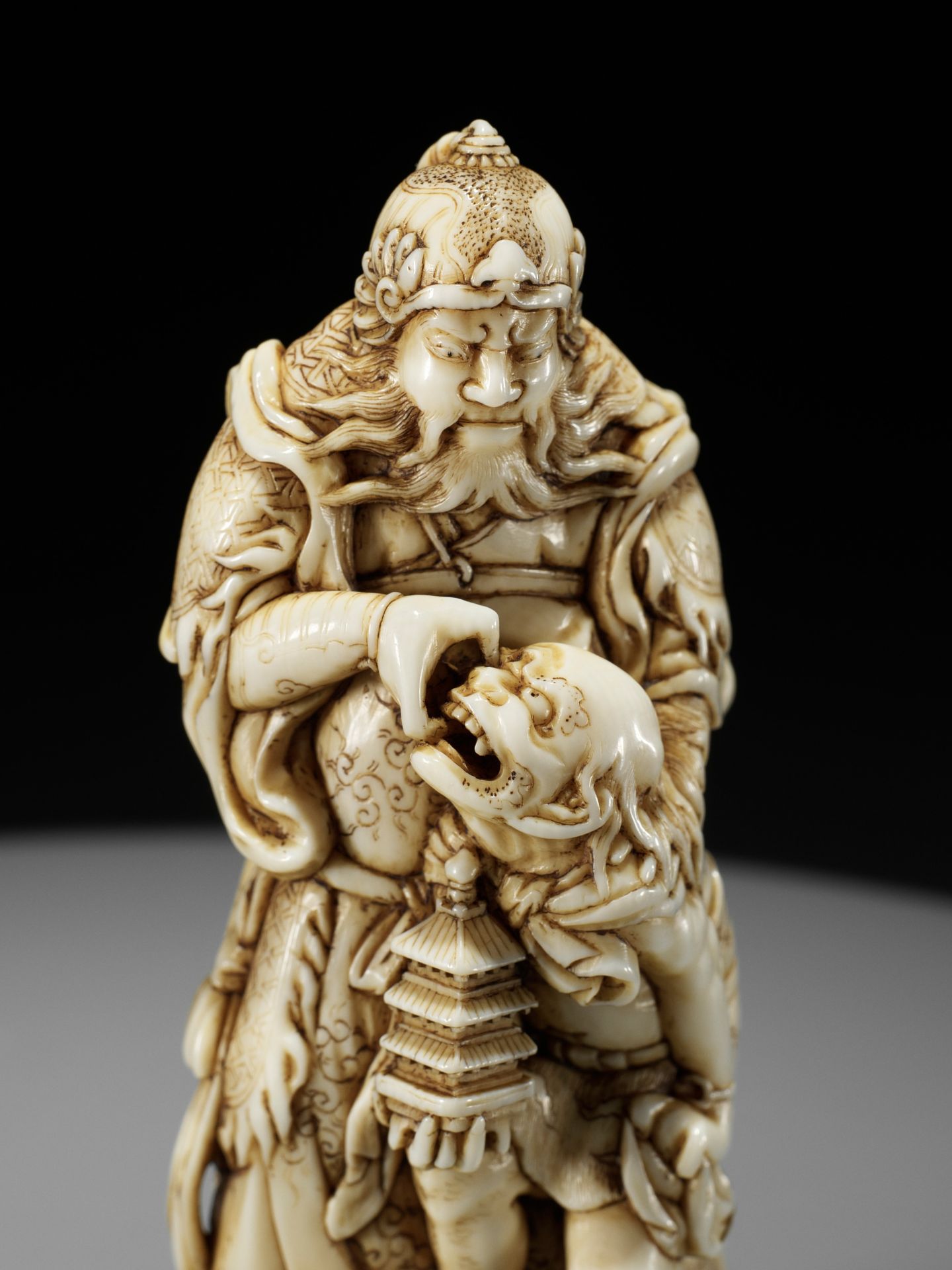 IKKOSAI: AN IMPORTANT AND LARGE IVORY NETSUKE OF IDATEN CAPTURING AN ONI