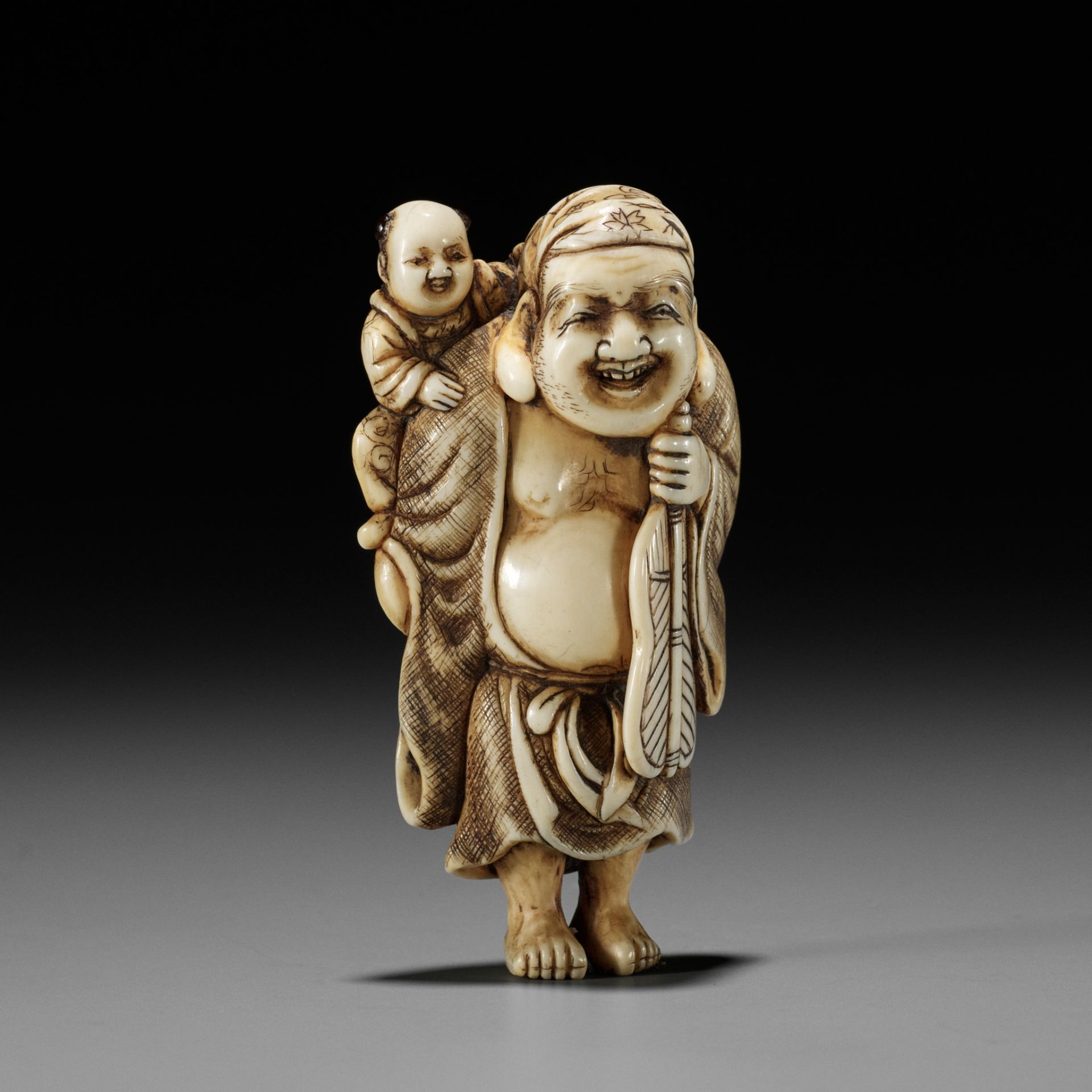 OKAKOTO: AN IVORY NETSUKE OF HOTEI WITH KARAKO