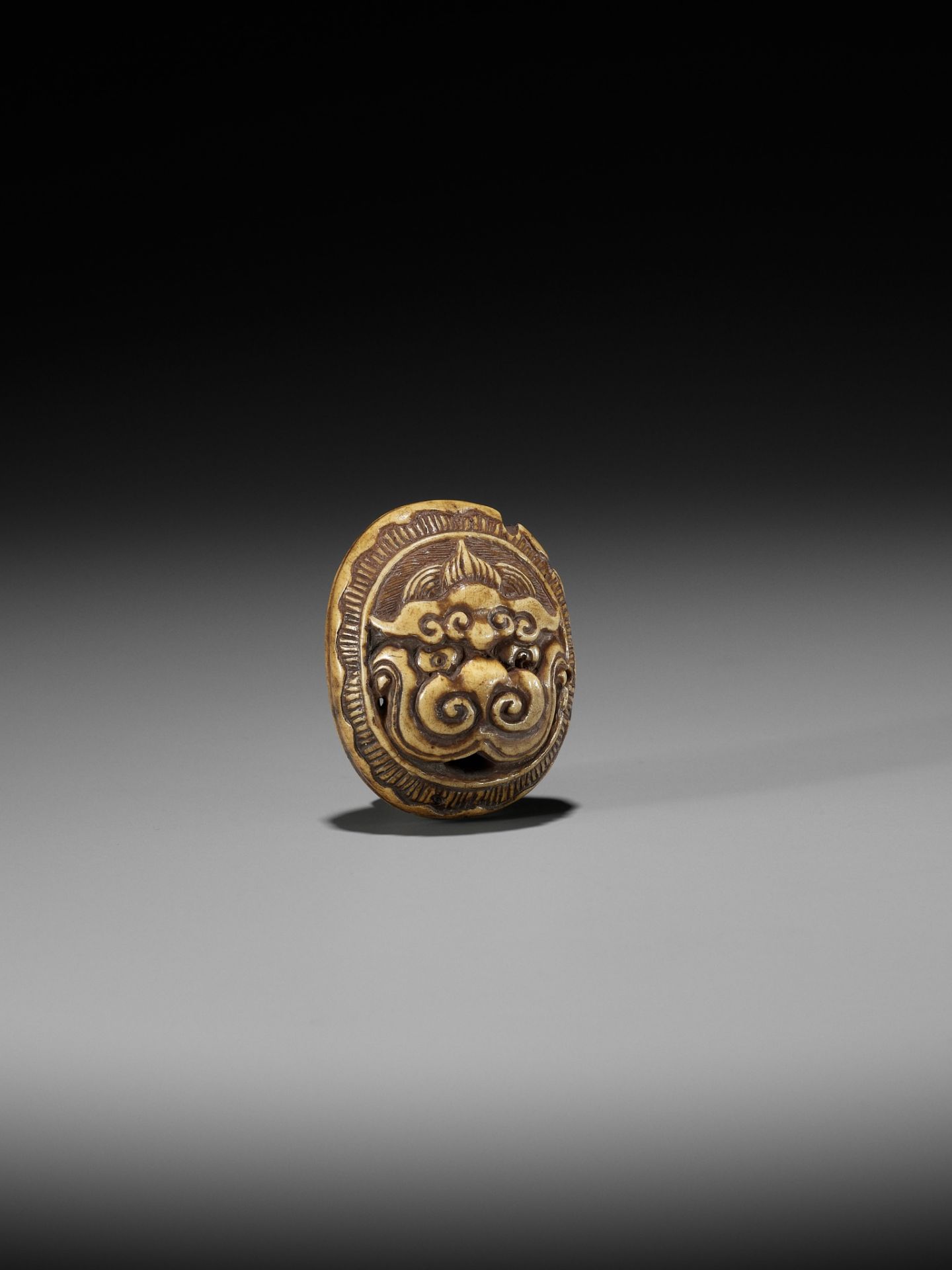 KOKUSAI: A STAG ANTLER RYUSA MANJU NETSUKE DEPICTING A ROOF TILE WITH ONI MASK (ONIGAWARA) - Image 7 of 14