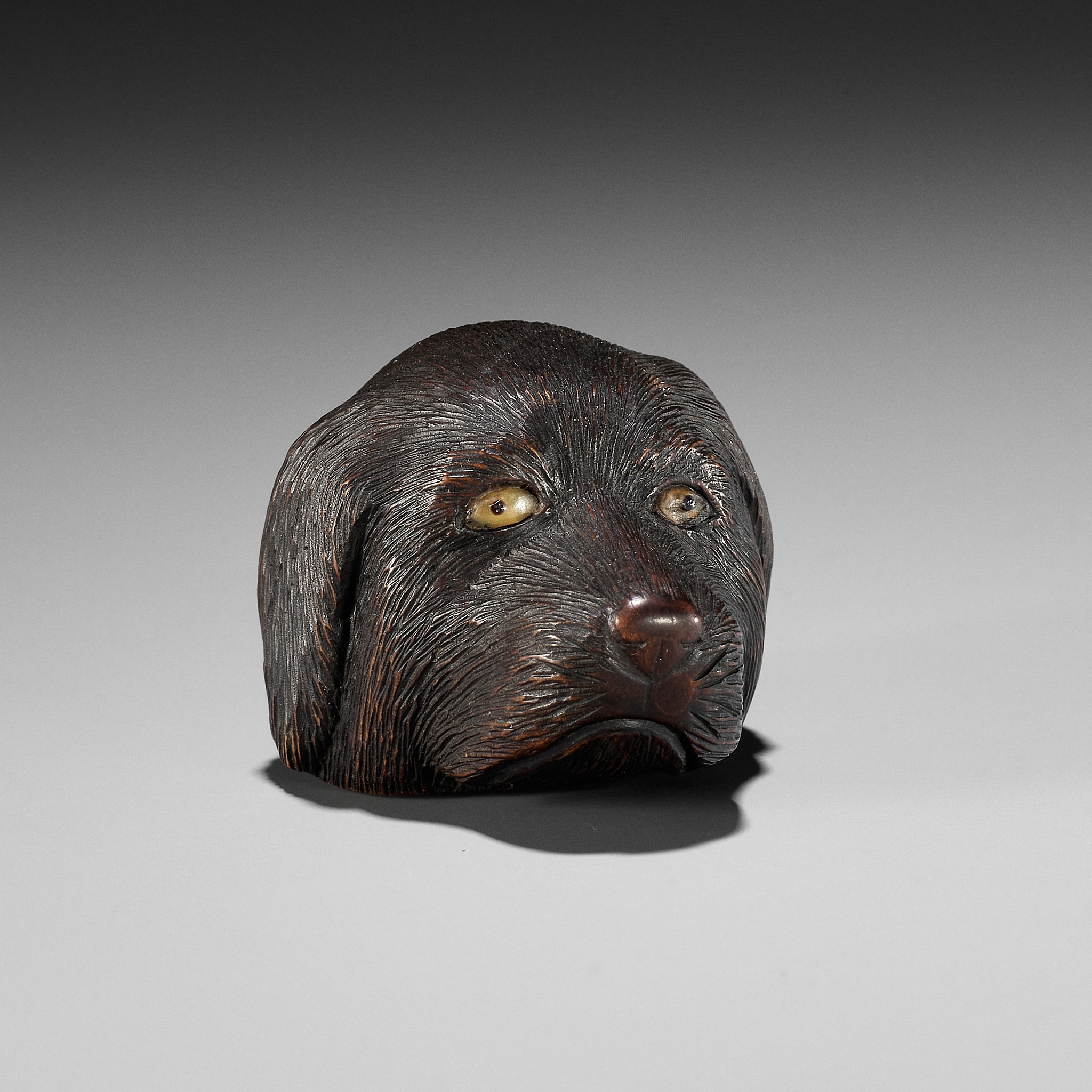 CHIKUSAI: A RARE WOOD NETSUKE DEPICTING THE HEAD OF A DOG