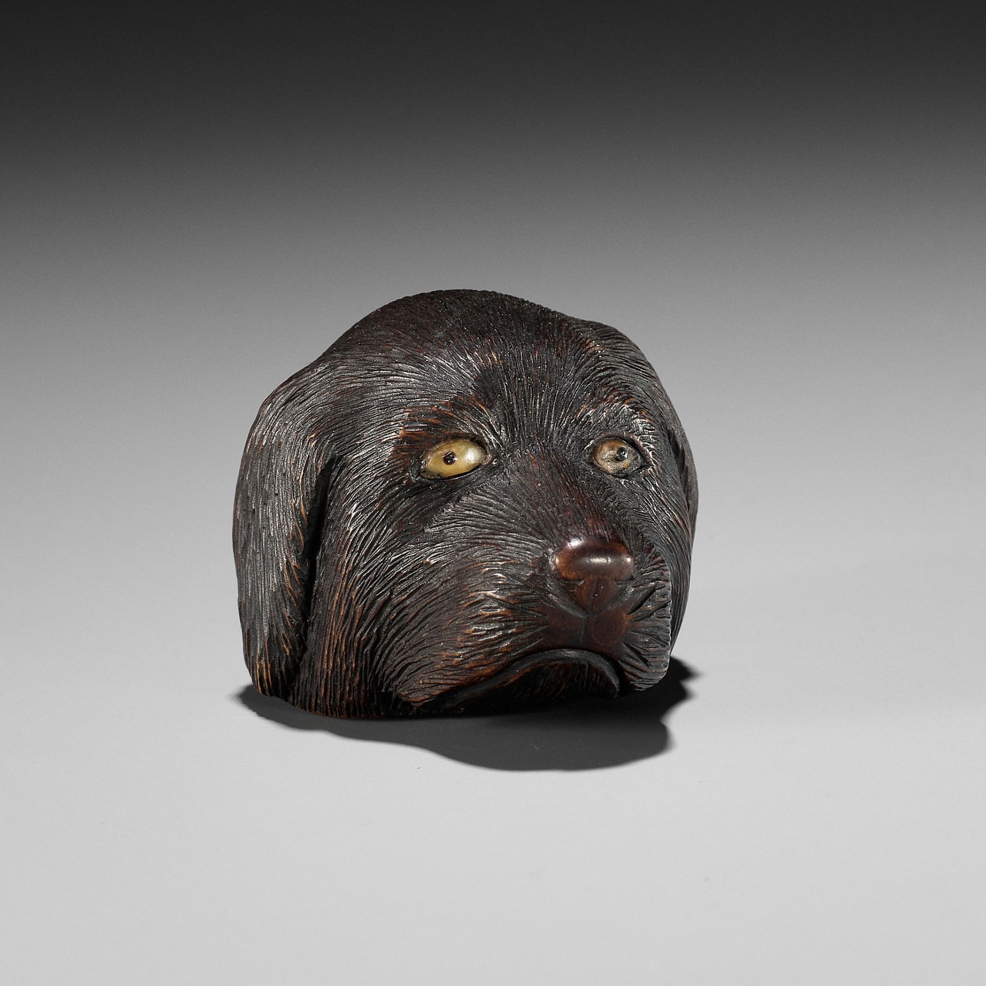 CHIKUSAI: A RARE WOOD NETSUKE DEPICTING THE HEAD OF A DOG